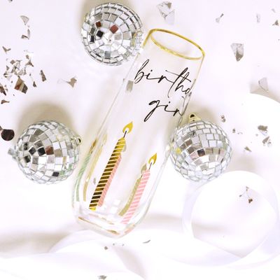 Birthday Girl stemless champagne glass filled with sparkling wine on a table setting