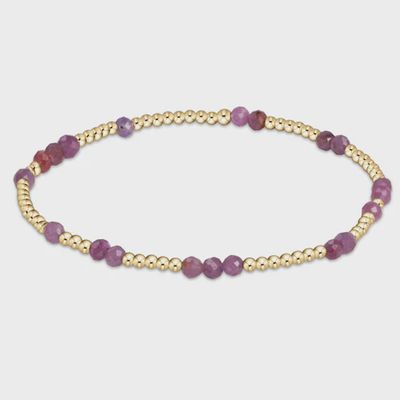 ENEWTON Hope Unwritten ruby gemstone bracelet in 14kt gold-filled metal, displayed against a neutral background