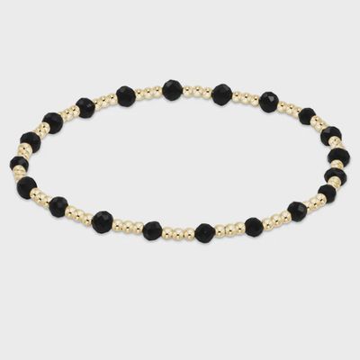 Sincerity bracelet with 3mm faceted black onyx beads and 14kt gold-filled spacer beads on white background