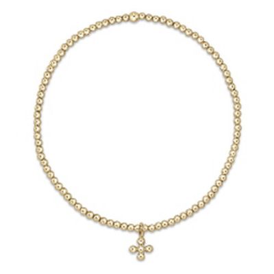 Gold beaded bracelet with 2mm beads and small signature cross charm on white background