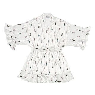 Bella IL Fiore ruffled satin robe in a soft neutral tone, worn in a relaxed lifestyle setting showing the draping satin fabric and layered ruffle details.