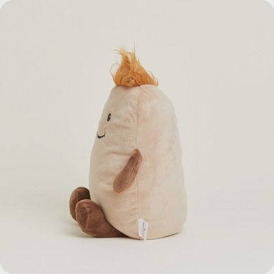 Warmies potato-shaped plush toy with lavender scent in a cozy home setting, showing the soft tan fabric and rounded form