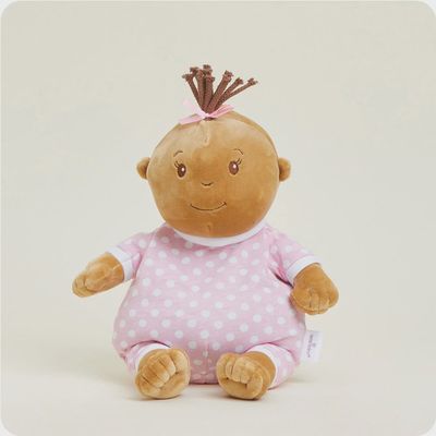Warmies lavender-scented weighted plush in soft pink fabric displayed in a nursery setting with gentle lighting