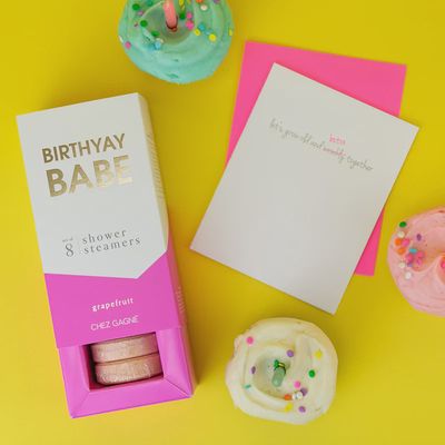Eight grapefruit-scented shower steamers from Chez Gagne's Birthday Babe collection arranged in a lifestyle setting.