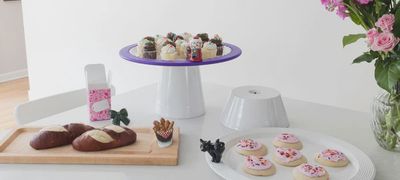 Maple wood serving board measuring 18 by 8 inches with circular attachment slot for interchangeable minis, displayed in a styled tabletop setting