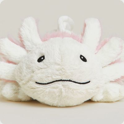 White plush axolotl toy with lavender scent in a cozy lifestyle setting, designed for microwave heating