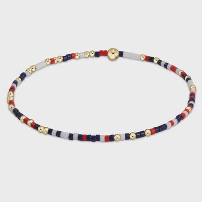 Firecracker beaded bracelet in 14k gold-filled metal with Hope Unwritten charm detail on neutral background