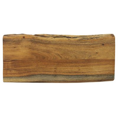Narrow acacia wood cutting board with natural live edge displayed on a kitchen counter with fresh ingredients