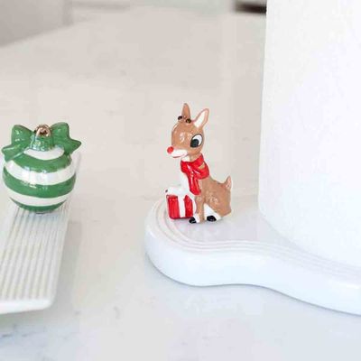 Nora Fleming pinstripe melamine paper towel holder displayed on a kitchen counter next to fresh lemons and a ceramic bowl