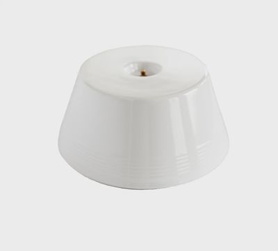 Nora Fleming melamine platter riser stand in white, shown from front angle against a neutral background