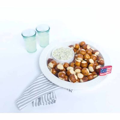 Melamine chip and dip bowl with pinstripe design in a table setting with snacks and appetizers