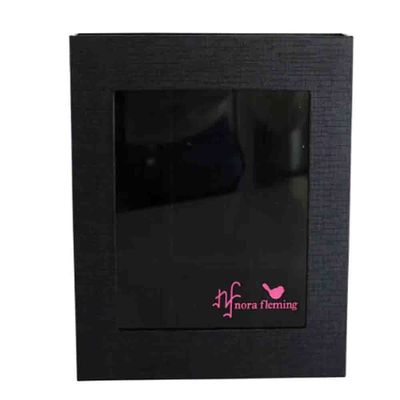 Nora Fleming keepsake storage box with magnetic closure displayed in a home setting, designed to hold nine mini attachments