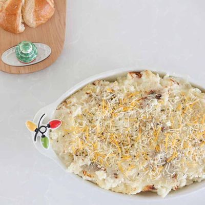 Nora Fleming oval baker with pinstripe pattern, 16 inches, displayed in a kitchen setting ready for oven use