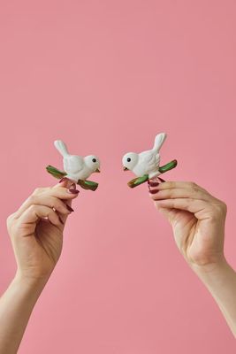 Nora Fleming Bestie Bird friendship dove mini collectible displayed in a lifestyle setting on a neutral surface.