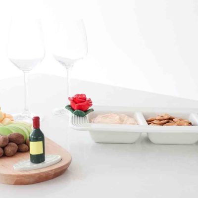 Nora Fleming Pinstripes Garnish Dish in a table setting, showing the 15.25-inch ceramic dish with striped pattern detail