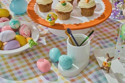 Nora Fleming robin's egg blue Easter mini displayed in a tabletop lifestyle setting with spring decor