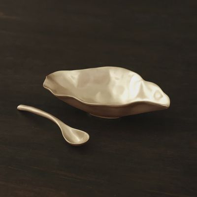 Beatriz Ball medium bowl and matching spoon in brushed gold finish, displayed in a styled home setting