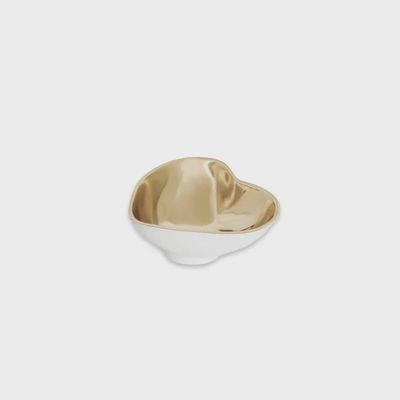 White ceramic heart-shaped mini bowl with champagne gold accents displayed in a home setting
