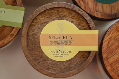 Spicy Rita Pineapple Habanero Cocktail Infusion Kit displayed in a home bar setting with fresh pineapple and habanero peppers