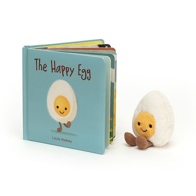 Jellycat The Happy Egg children's picture book displayed on a soft surface with warm lighting
