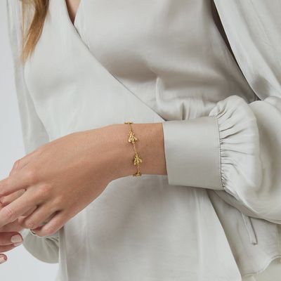 Julie Vos Bee Station delicate chain bracelet with gold-toned links and bee charm detail worn on wrist in lifestyle setting