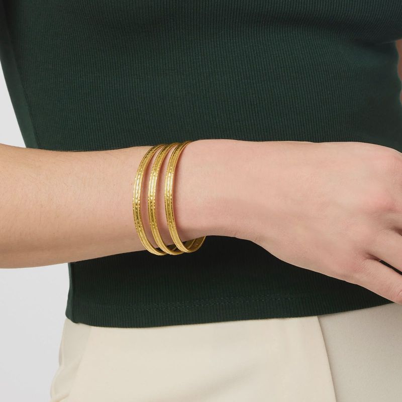Hand-hammered golden bangle from Julie Vos Madison collection worn on wrist in lifestyle setting