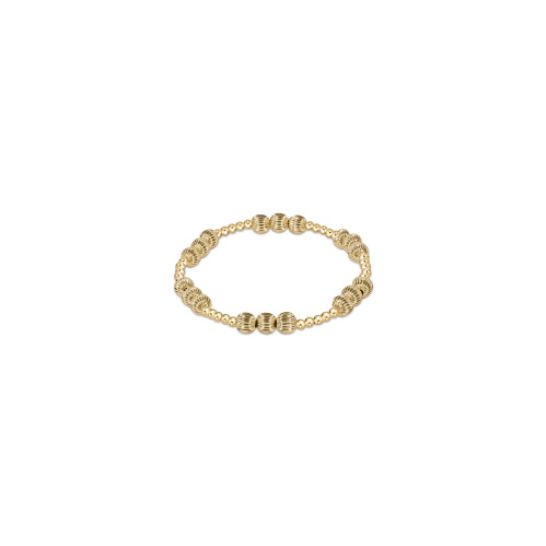 Gold-filled bead bracelet with small round beads in 14kt gold finish, worn on wrist in lifestyle setting