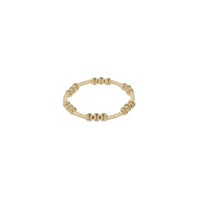 Gold-filled bead bracelet with small round beads in 14kt gold finish, worn on wrist in lifestyle setting