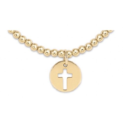 Gold-filled 3mm beaded bracelet with 12mm blessed charm worn on wrist in lifestyle setting