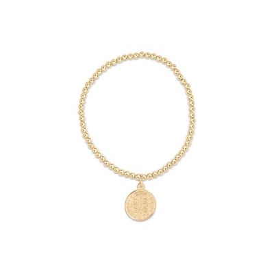 Gold-filled 3mm beaded bracelet with Saint Benedict blessing disc charm worn on wrist in natural light