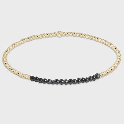 Gold Bliss hematite bead bracelet with 2mm faceted beads and gold accents on white background
