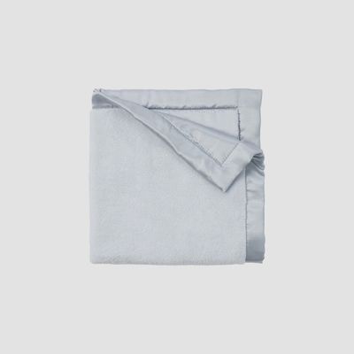 Satin-trim flannel fleece security blanket in soft neutral tones, 20x20 inches, shown in a lifestyle setting.