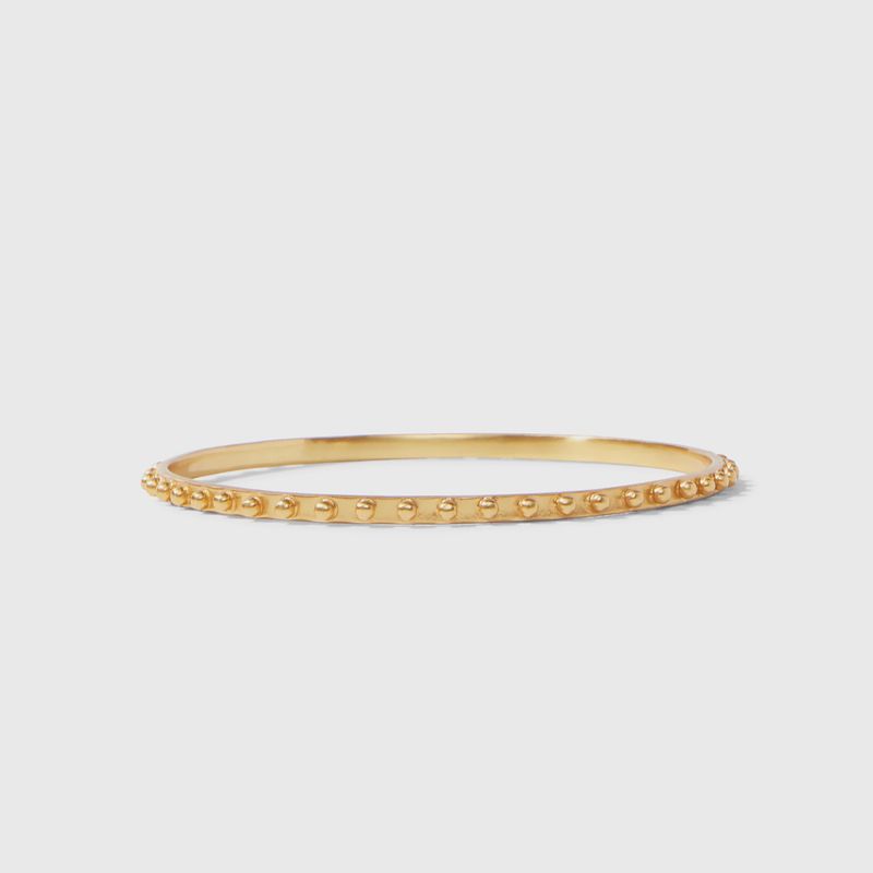 Gold and mixed metal studded stacking bangle from Julie Vos displayed on wrist in lifestyle setting