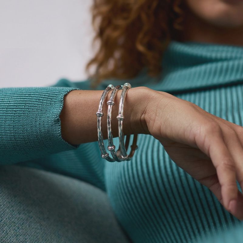 Julie Vos Savannah tarnish-free silver plate bangle bracelet worn on wrist in lifestyle setting