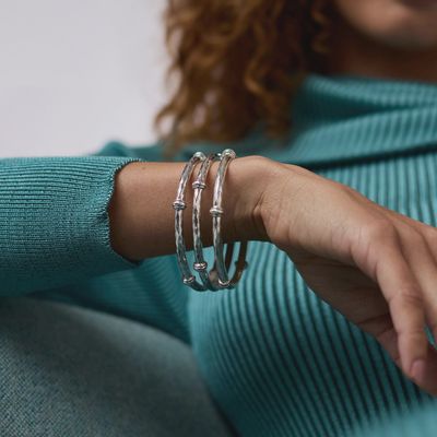 Julie Vos Savannah tarnish-free silver plate bangle bracelet worn on wrist in lifestyle setting