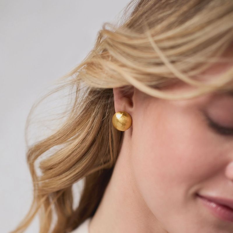Julie Vos Solara stud earrings in 24K gold plate with pierced posts, shown in lifestyle setting