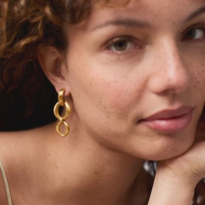 Julie Vos Solara Orbit Post Earrings in 24K gold plate, 1.9 inches, worn in a lifestyle setting