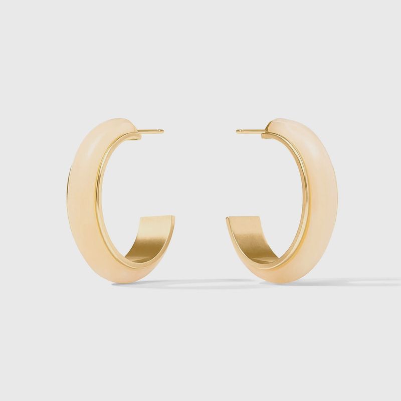 Julie Vos Carnaby hoop earrings in 24K gold plate and acetate, worn in a lifestyle setting