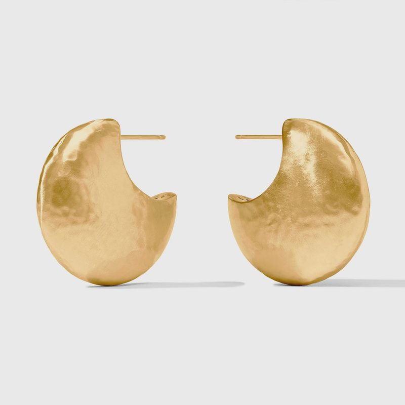 Julie Vos Solara hoop earrings in 24K gold plate, displayed in a lifestyle setting with pierced ear styling