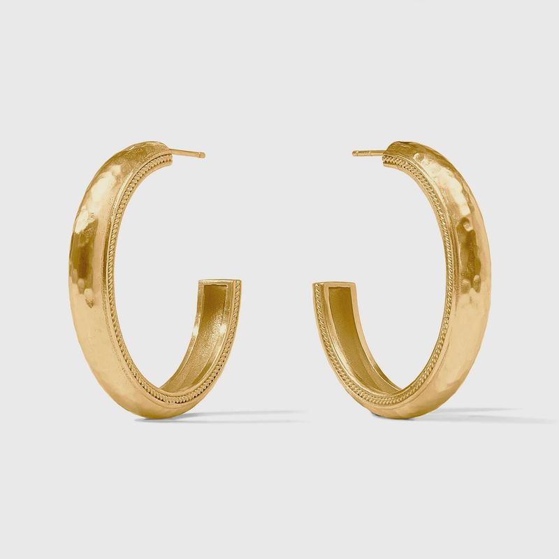 Julie Vos Cannes hoop earrings in 24K gold plate, worn in a lifestyle setting