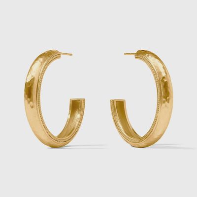 Julie Vos Cannes hoop earrings in 24K gold plate, worn in a lifestyle setting