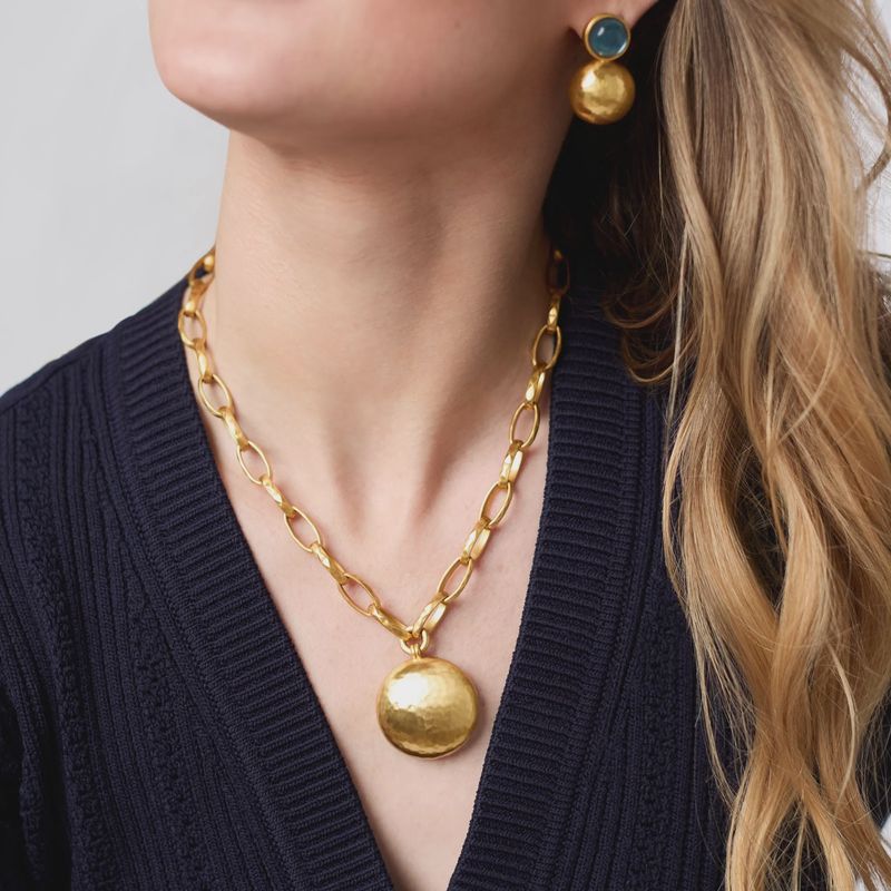 Julie Vos Solara necklace in 24K gold plate with toggle clasp, displayed in a lifestyle setting