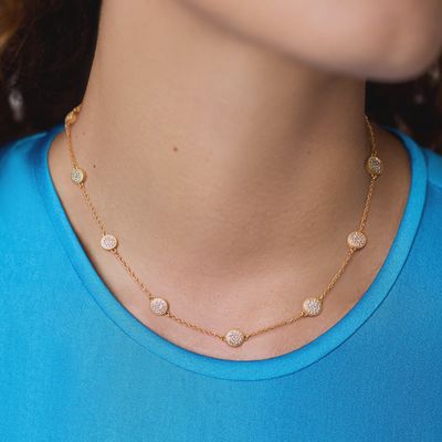 Windsor CZ station necklace in 24K gold plate worn as a layered pendant, showing the cubic zirconia stations along an adjustable chain.