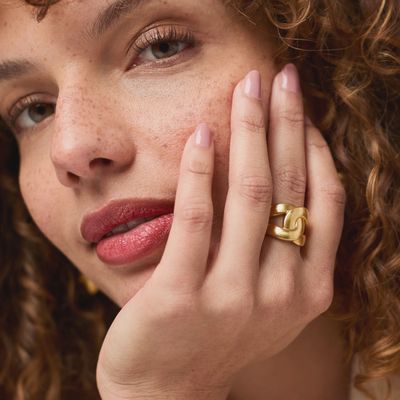Julie Vos Infinity Ring in 24K gold plate worn on hand in natural light, showcasing the polished band and luxurious finish