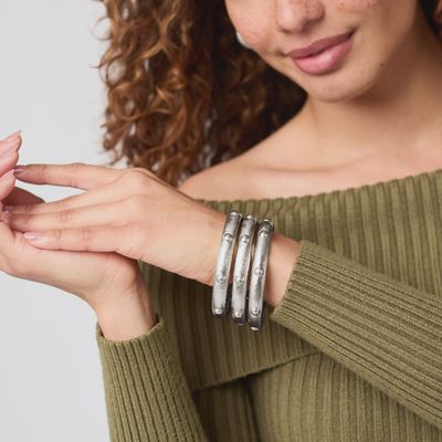 Julie Vos Solara tarnish-free silver plate bangle bracelet worn on wrist in lifestyle setting