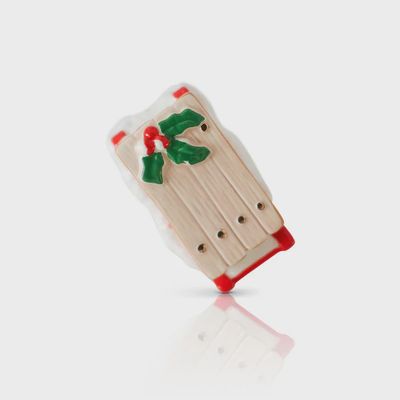 Nora Fleming Ho Ho Woah! Vintage Sled Mini decorative piece displayed on neutral background in studio setting