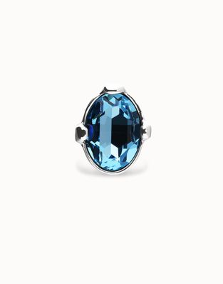 Large blue oval crystal ring by Uno de 50 displayed against a neutral studio background