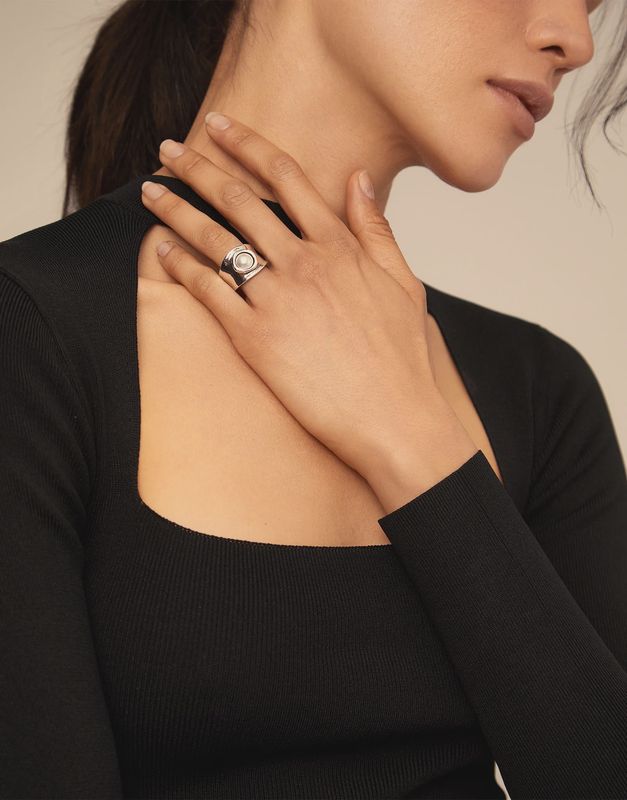Uno de 50 pearl Swarovski crystal sterling silver ring worn on hand, showcasing the iridescent crystal detail and polished silver band