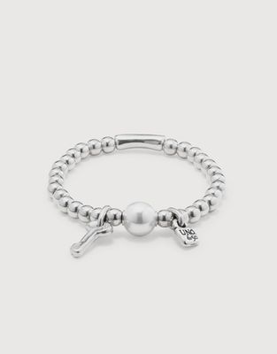 Silver-plated stretch bracelet with pearl and key charm details on white background