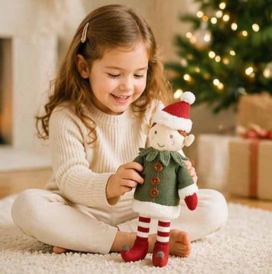Child playing with soft knit Christmas elf plush toy in cozy holiday living room setting